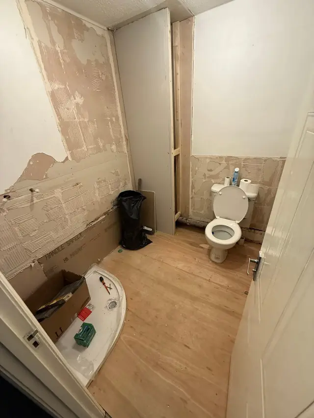 During: the old bathroom stripped out, back to the floorboards.