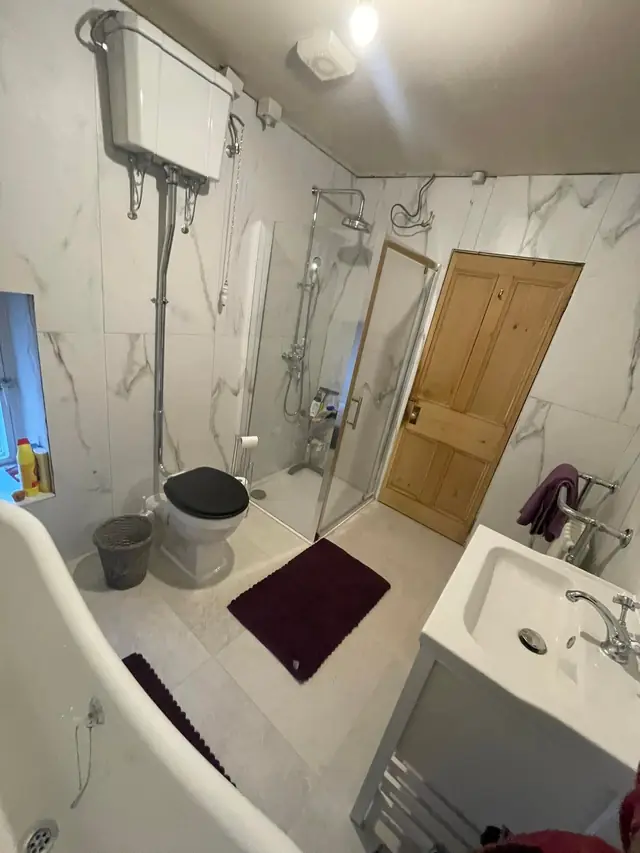 After: the room from the bath end, looking towards the vanity unit and door.
