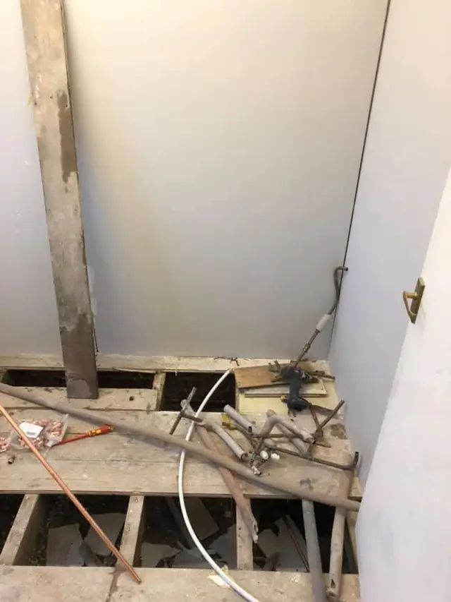 During: the floorboards lifted for the new pipework.