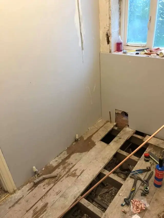 During: new pipes under the floor and new boards on the walls.