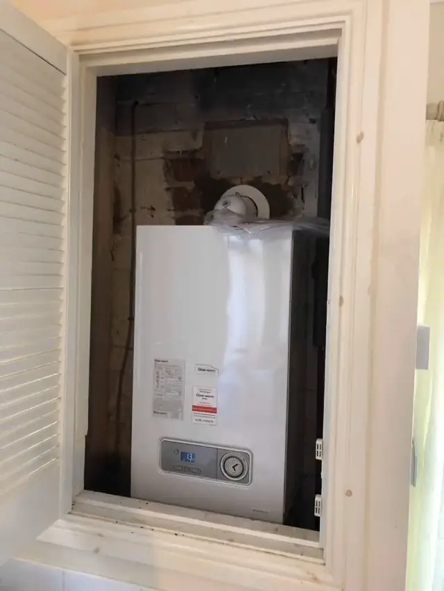 The new boiler fitted in the same cupboard.