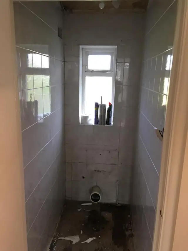 Before: the separate toilet with white wall tiles, the old toilet already taken out.