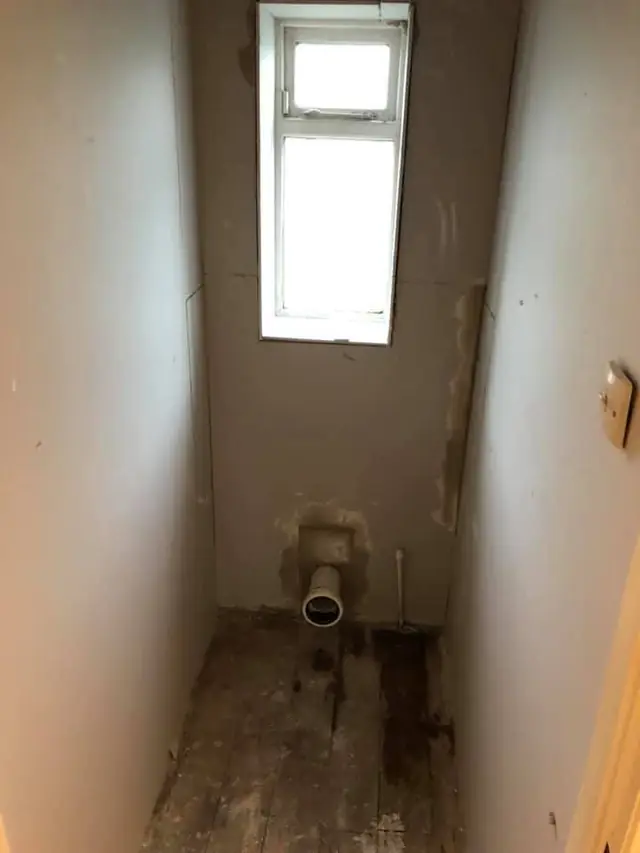 During: the separate toilet stripped back to plaster.